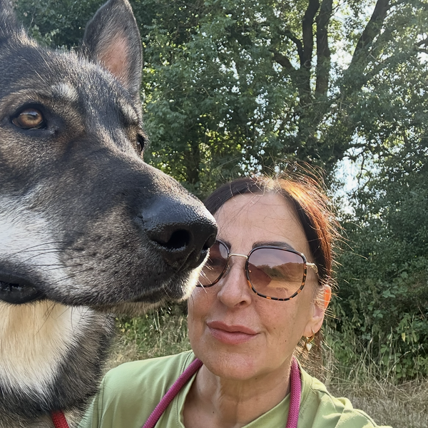 Alisa, founder of The Dogs Club, with her dog outdoors